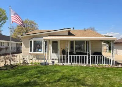 Michigan home with tan siding, white aluminum awning, and matching white railing built by Wayne Craft