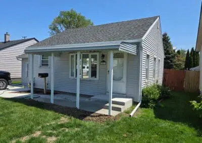 Single-story Michigan home featuring a white aluminum awning built by Wayne Craft