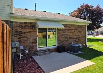 Brick home with a white aluminum awning built by Wayne Craft