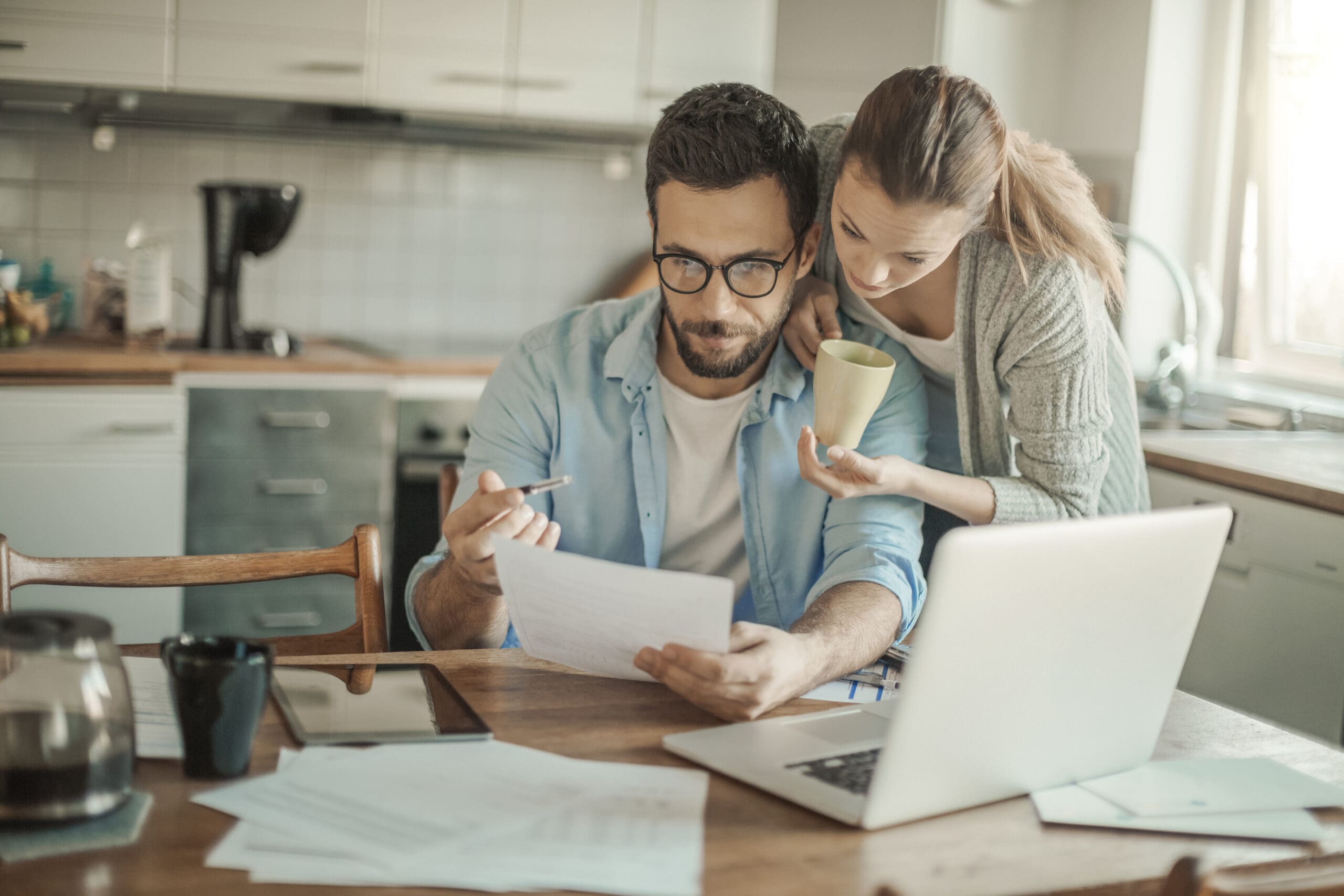 A husband and wife planning how to make their home additions budget-friendly