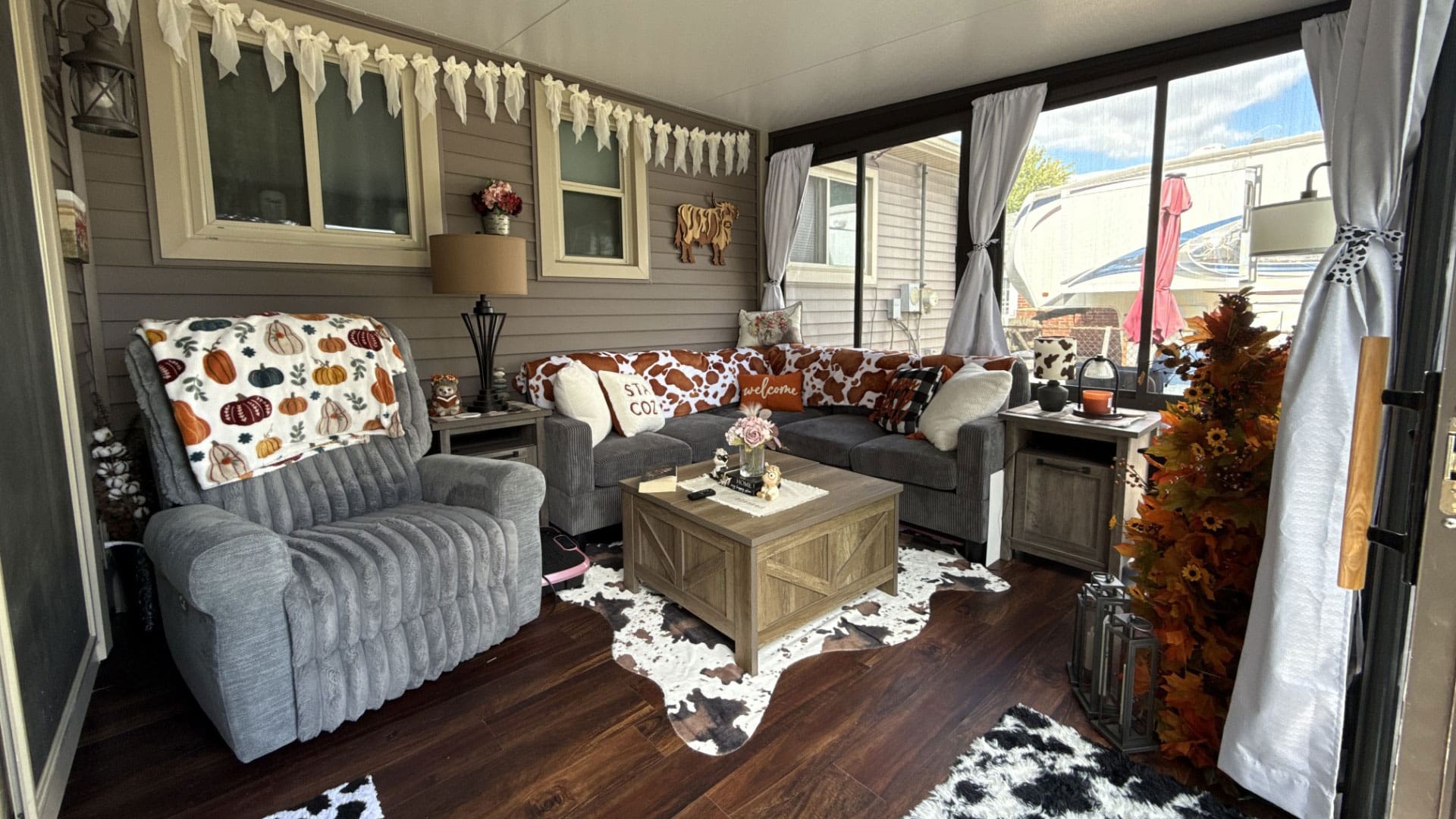 A cozy enclosed porch decorated for autumn